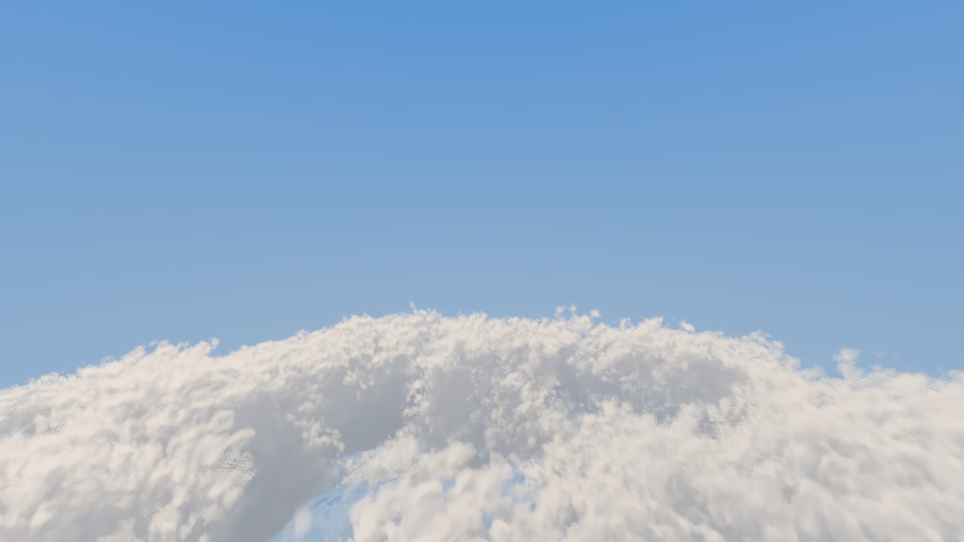 Just above the deck: a bank of sunlit cloud tops under a clear blue sky
