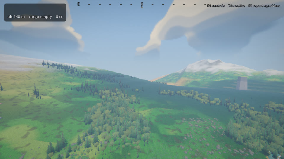 A wide forested valley seen from altitude, tree cover running unbroken up a slope toward a distant snow-capped peak