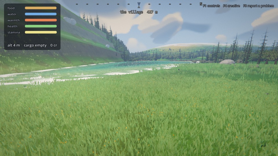 A turquoise backwater lake filling a valley below wooded slopes, a river feeding it from the left, grass meeting the water on the near shore