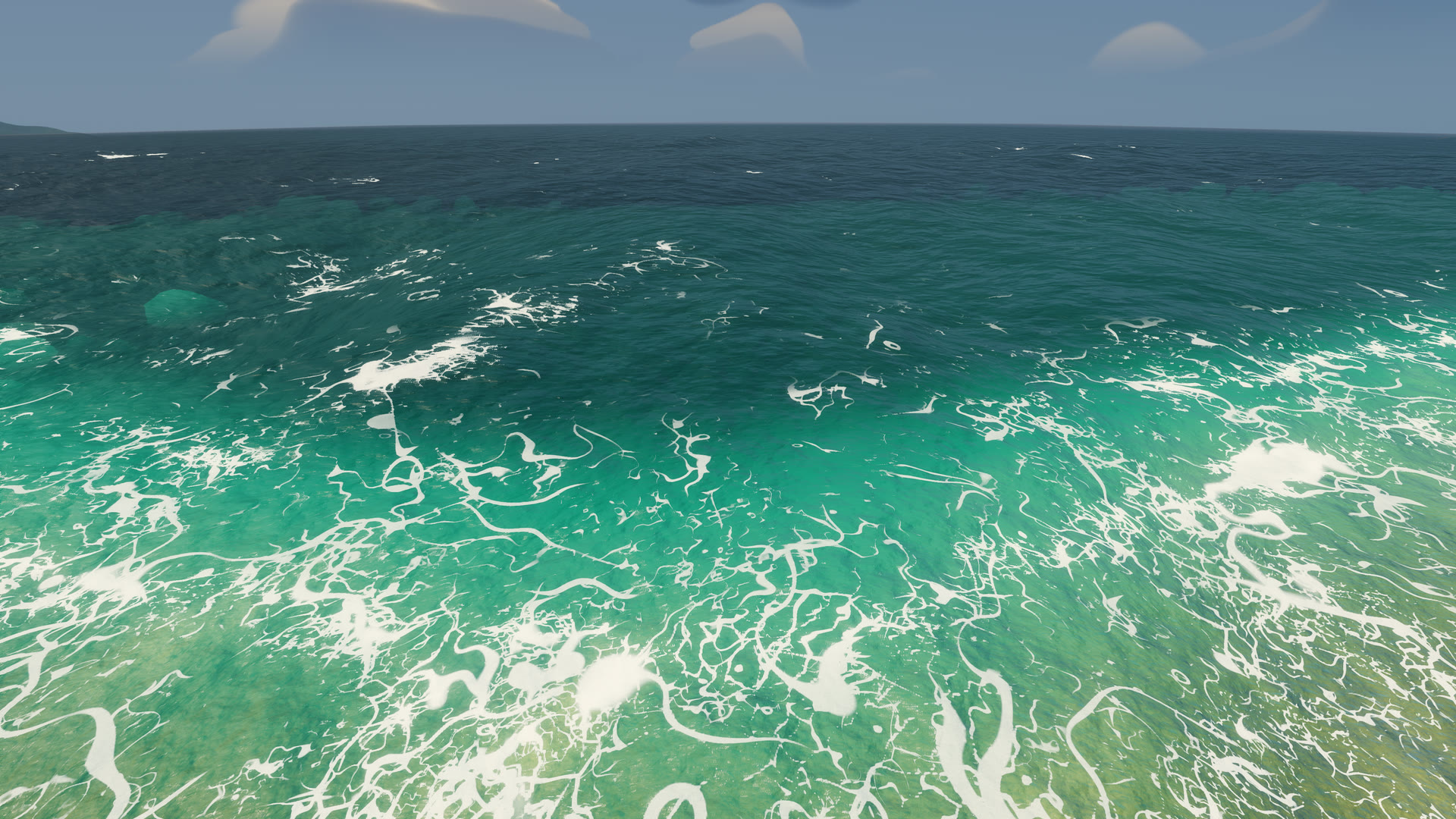 Turquoise water over a shallow sand shelf, covered in a dense net of white foam veins, deeper teal water beyond