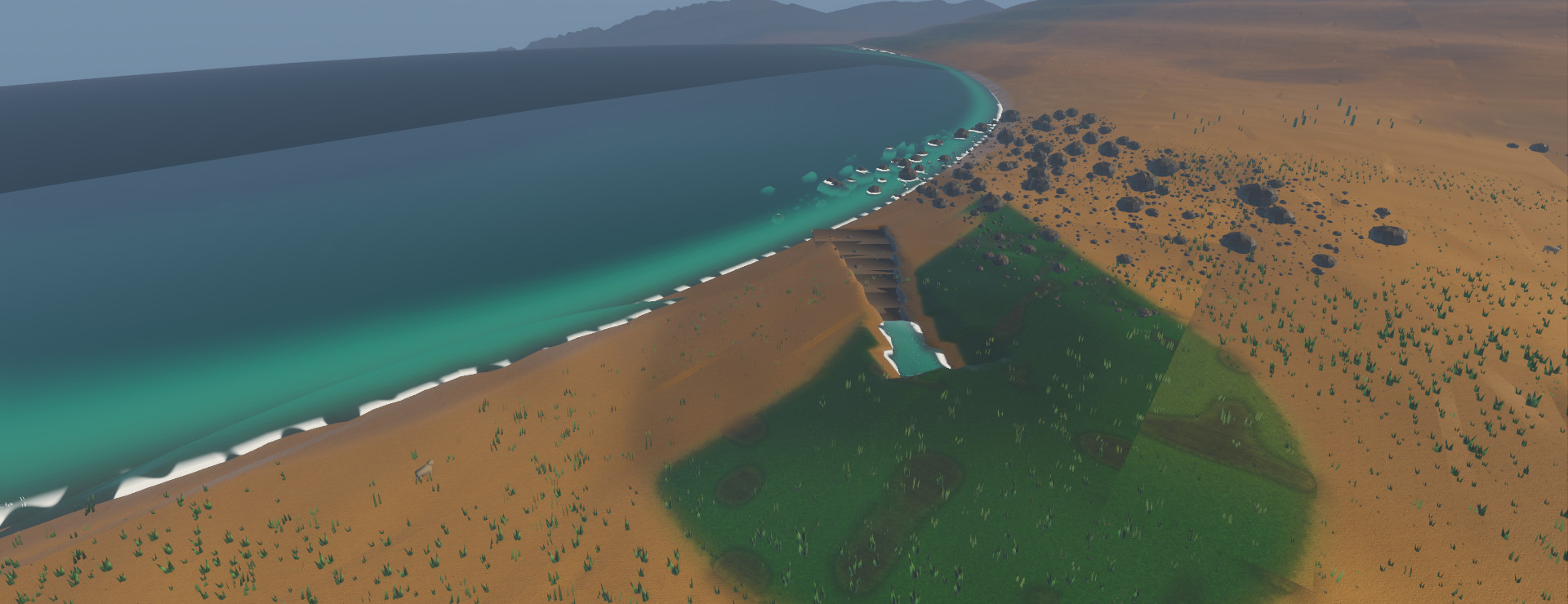 A river cutting through a sandy beach into a turquoise sea, seen from above, with a long curving shoreline and hills beyond